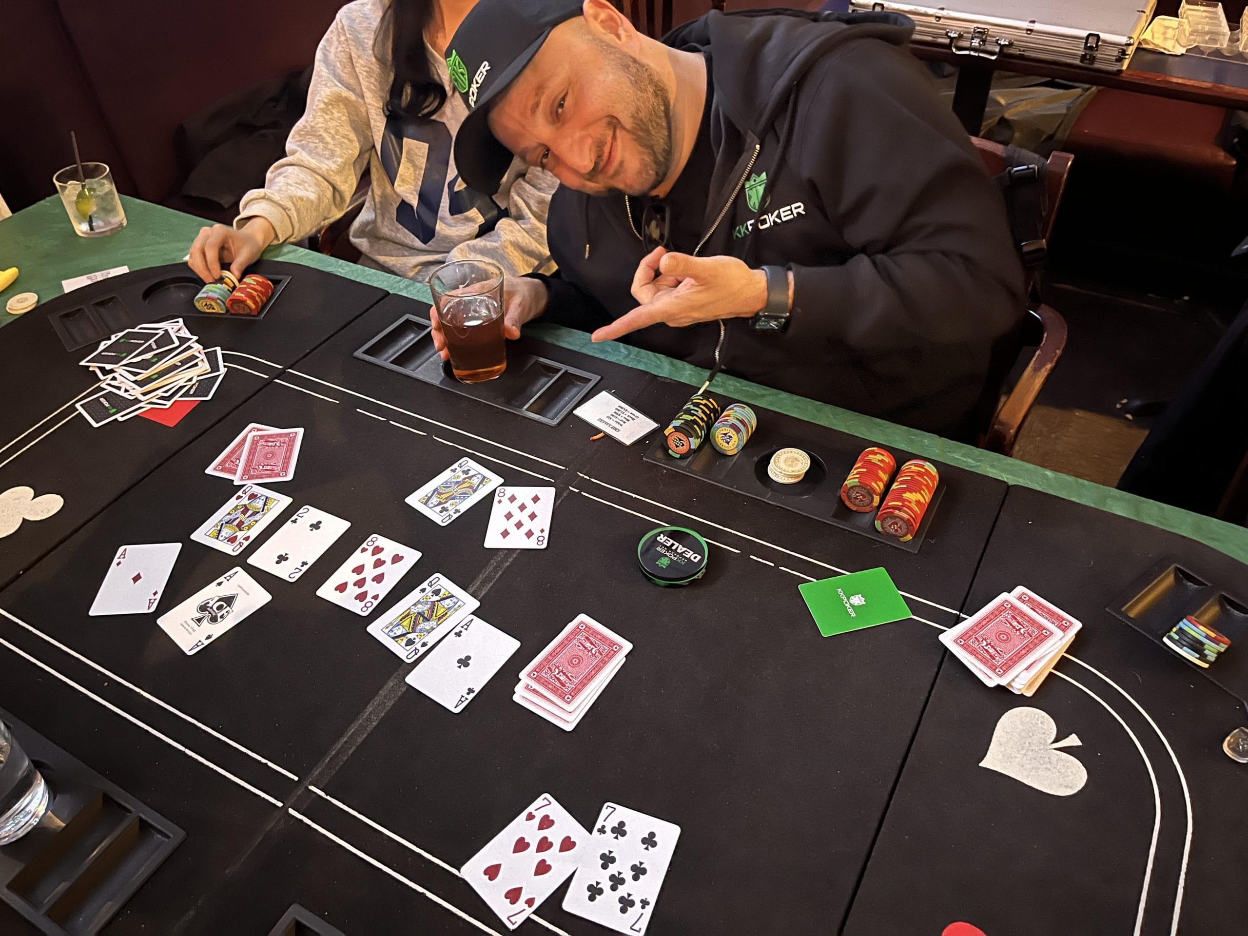 Mixed group of players around poker table at free Tuesday night poker Village Pub Vancouver