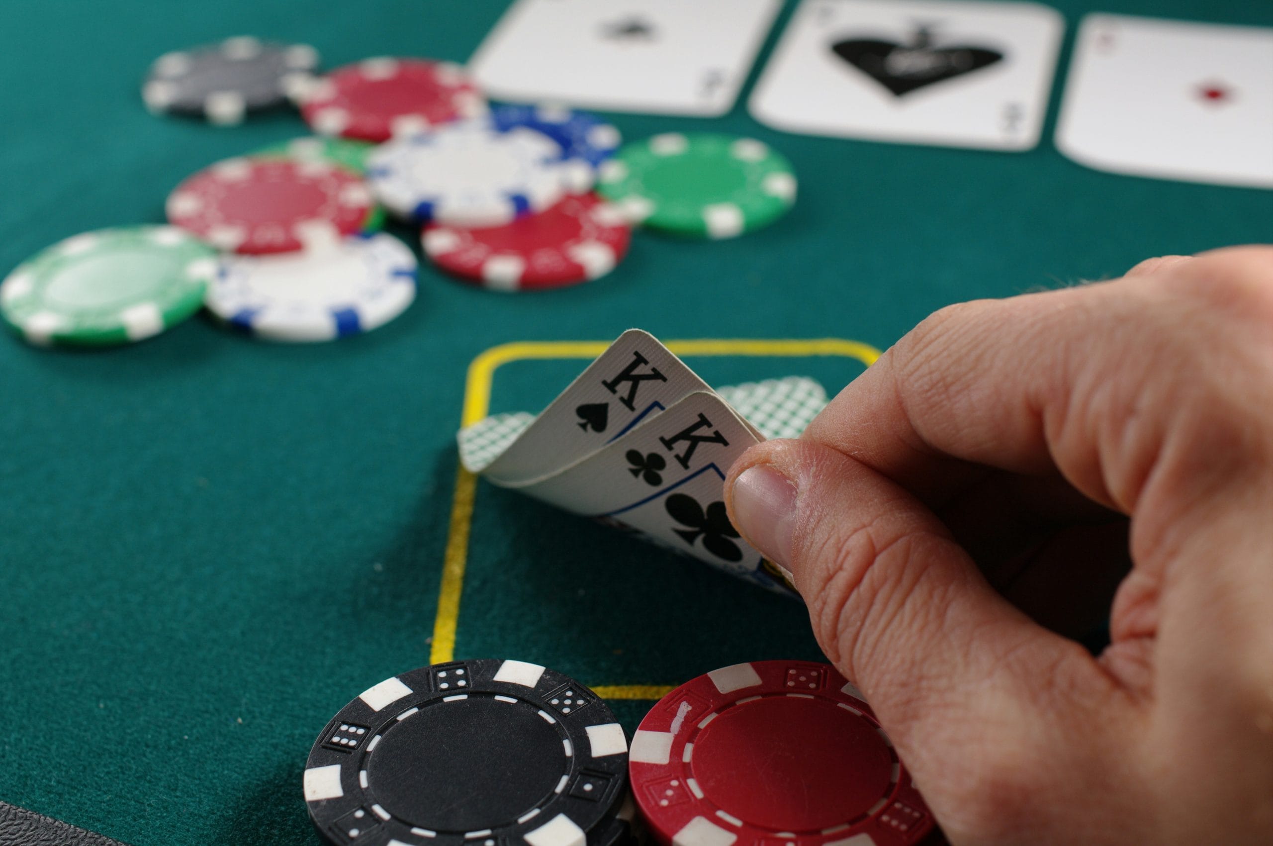 Player checking pocket cards during one of Vancouver's casual poker nights